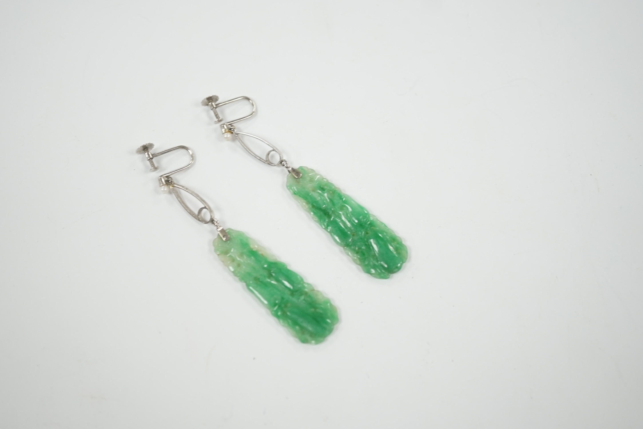 A pair of 9ct white metal, seed pearl and carved jade set drop ear clips, overall 7cm.